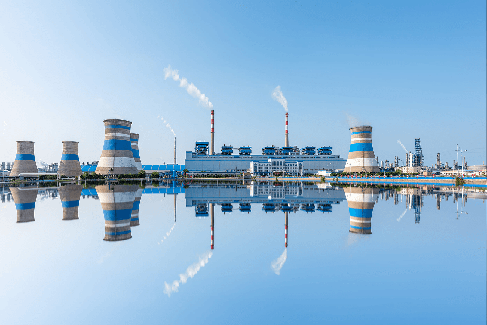 Industrial power facility reflected in water